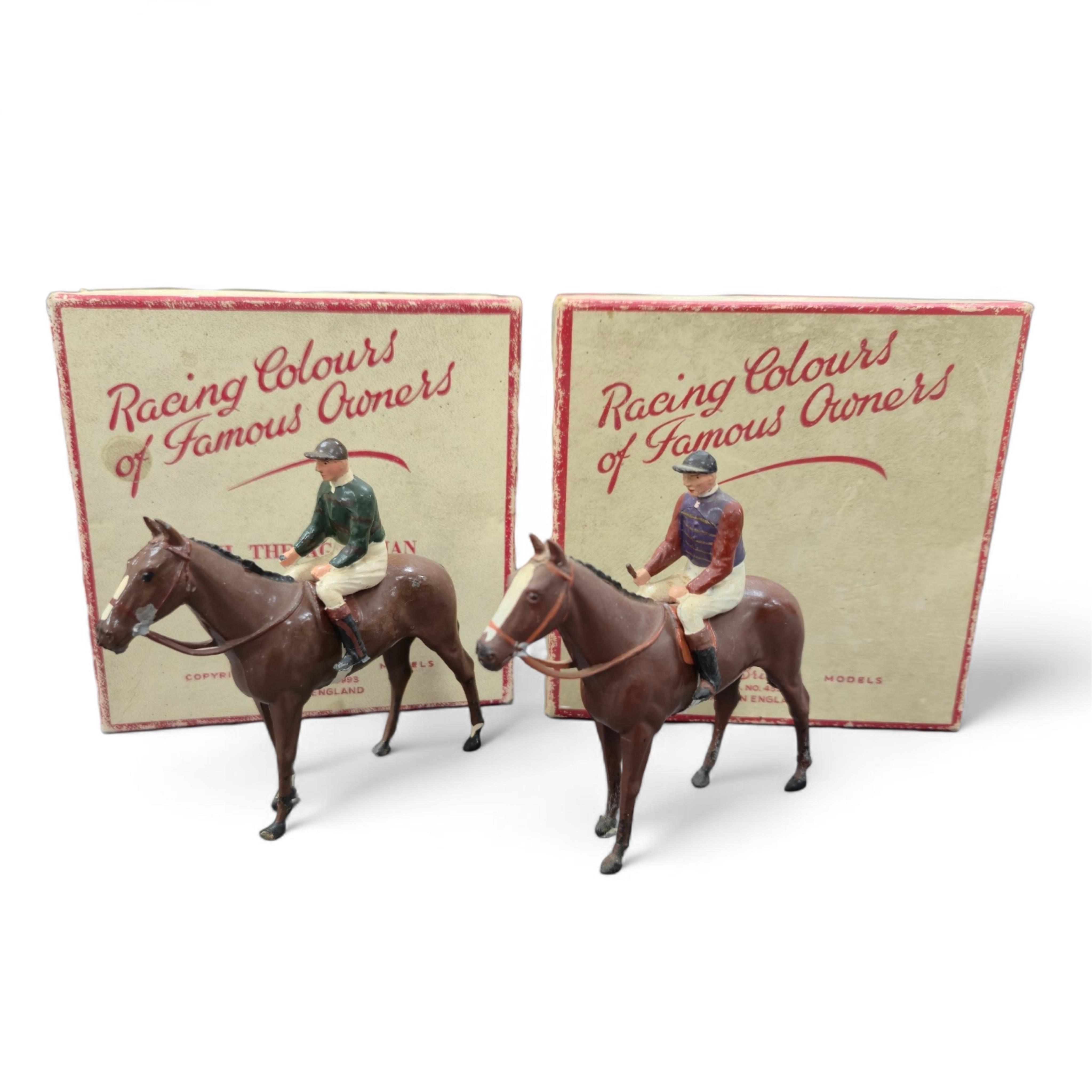 Two boxed Britains Racing Colours of Famous Owners series lead mounted figures; H.M. The Queen - rider in purple and brown jersey with gold frogging on a brown horse, and H.H. The Aga Khan - rider in dark green jersey on